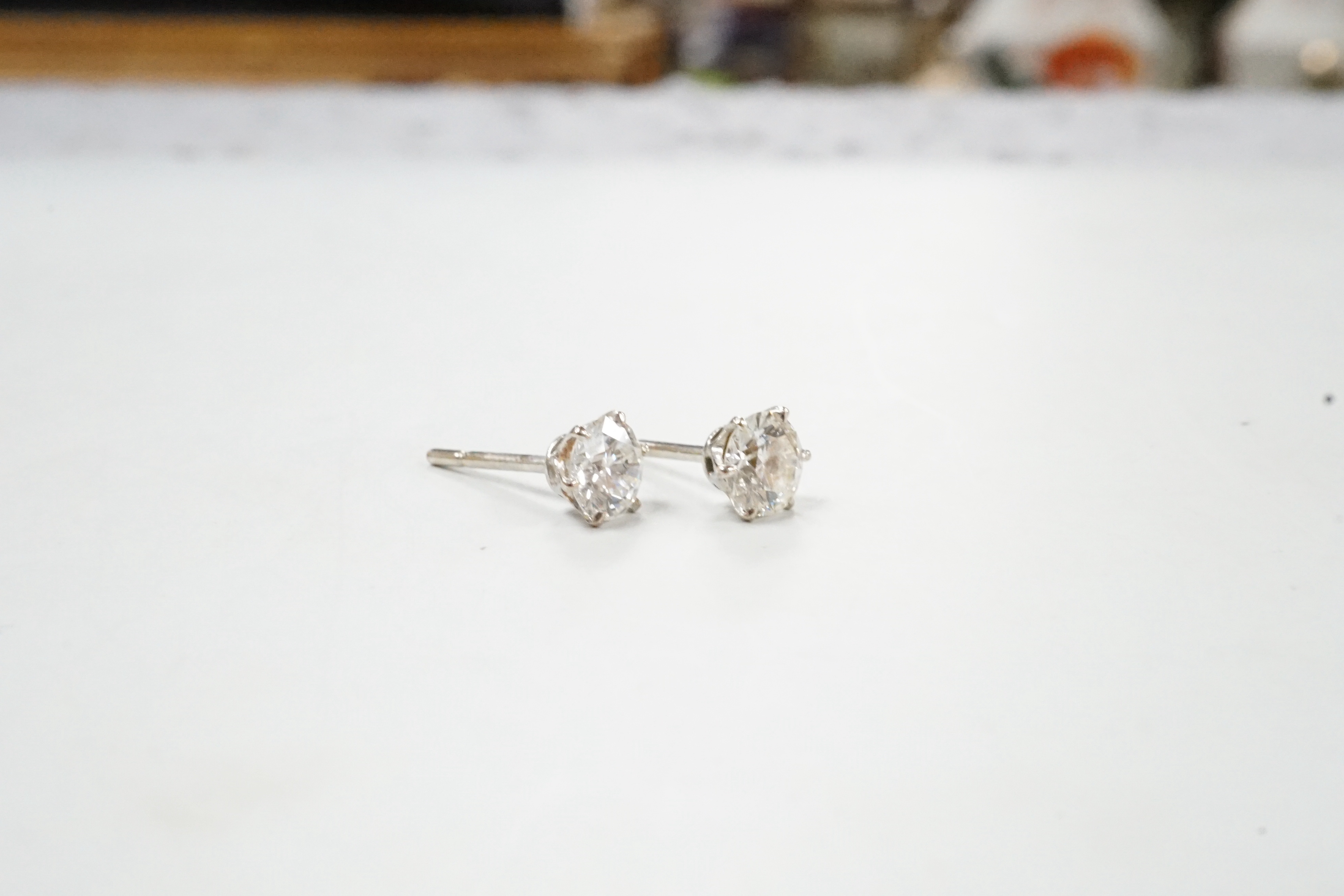 A pair of white metal and solitaire diamond set ear studs